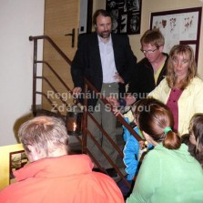 Muzejník s lucernou vede návštěvníky do podkroví. Foto: Kamila Dvořáková